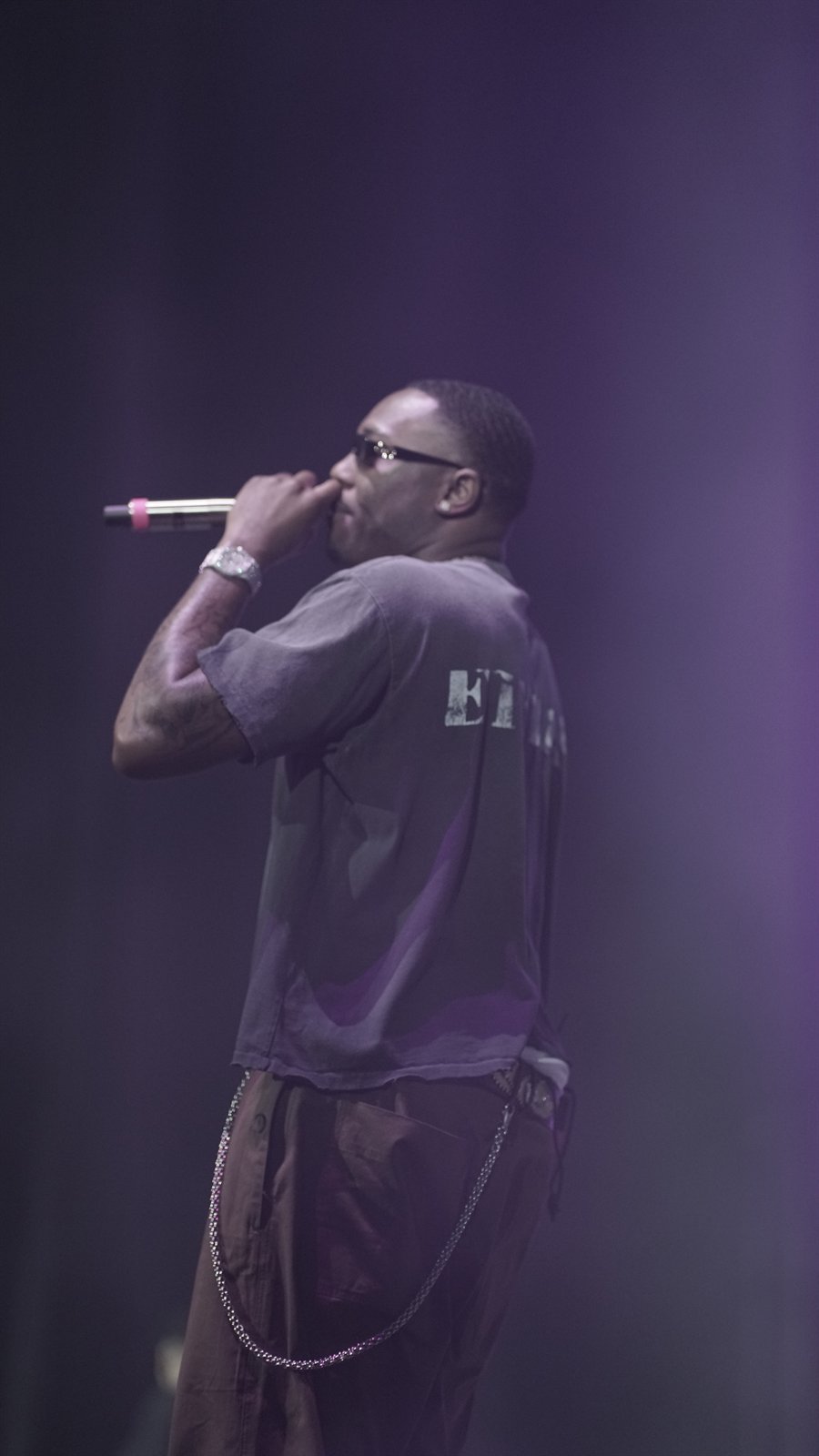 Performer on stage in purple light